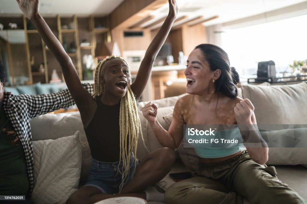 Friends together watching sports on television at home Sport Stock Photo
