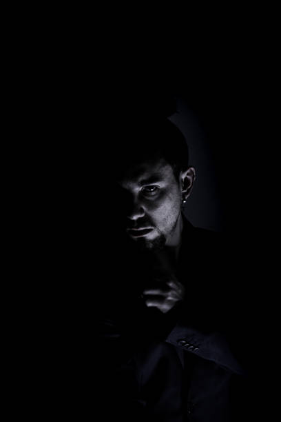 istock Vertical portrait of scared serious man in the dark 1314762054