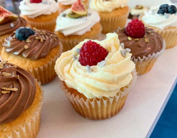 istock Close up view of cupcake with white vanilla frosting and fresh raspberry 1314763364