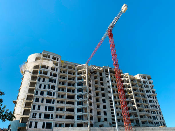 istock Construction of the multi-story building. High rise construction site with concrete building and crane. 1314763420