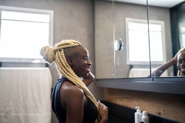 istock Woman looking in the mirror at home 1314765793