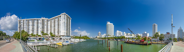MIAMI BEACH, FL - FEBRUARY 26, 2016: Panoramic view of city river, bridge and buildings on a winter sunny day.