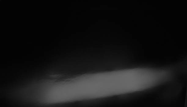 detail of black bodywork, with light reflection, part of automobile