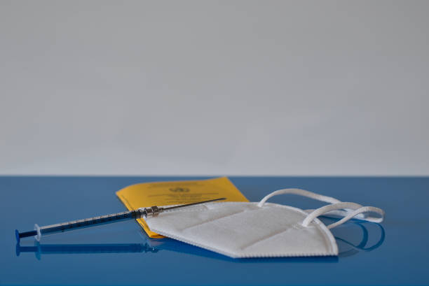 istock vaccination card Corona vaccination syringe 1314768277