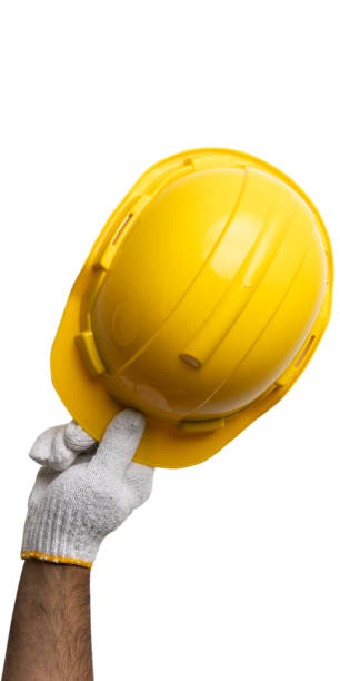 istock Hands mechanic holding yellow helmet tools isolated on white background. With clipping path. 1314768434