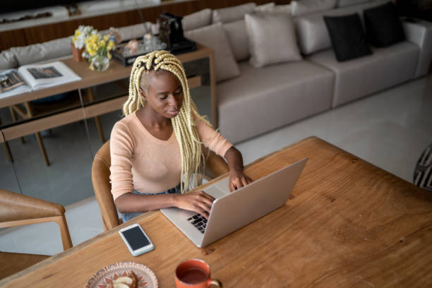 istock Young woman using laptop working at home 1314770007