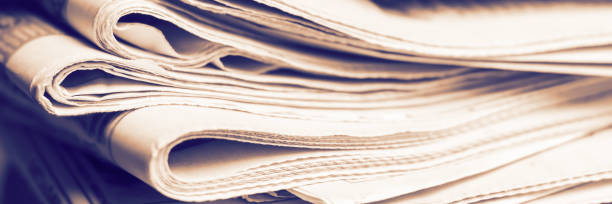 istock A stack of old newspapers. Media news concept. Panoramic image. Soft focus. 1314770342
