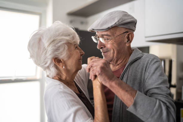 Senior couple dancing at home