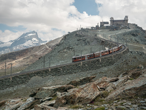07/30/2020 Gornergrat glacier, Valais canton, Switzerland.\nA tourist train moving up to the obersavatory on top of the mountain.