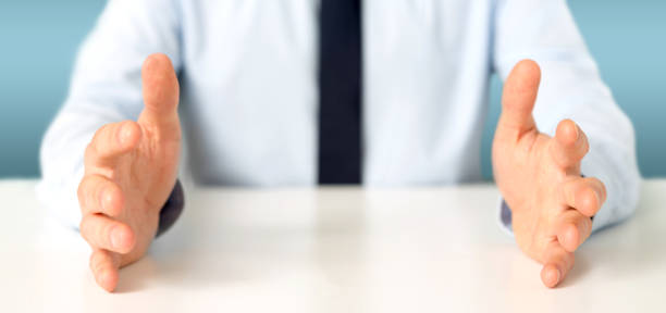 istock Empty holding hands of a  businessman over a desk 1314774218