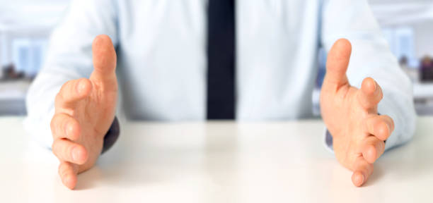 istock Empty holding hands of a  businessman over a desk 1314774262