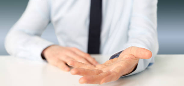 istock Empty holding hands of a  businessman over a desk 1314774478