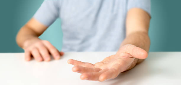istock Empty holding hands of a young relaxed man over a desk 1314774532