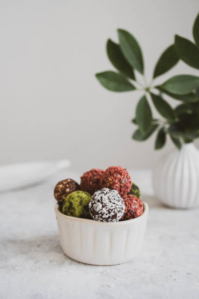 istock energy balls on a light table, bowl. Homemade healthy sweets 1314777311
