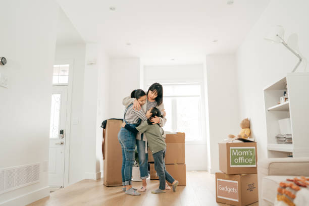 istock Mom and daughter moving boxes into new house 1314779045