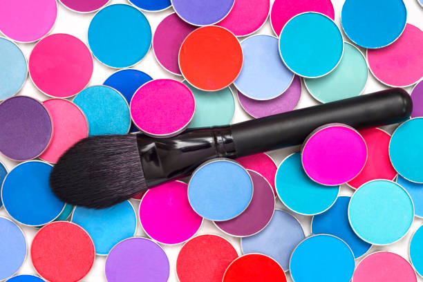 Makeup brush and multi-colored shadows.  Cosmetic products for makeup artist.