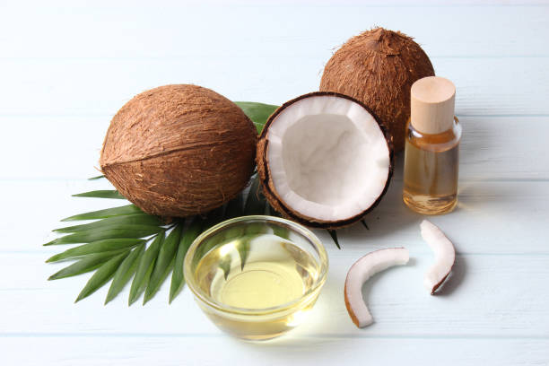 istock coconut oil and coconuts, palm branches close up 1314781006