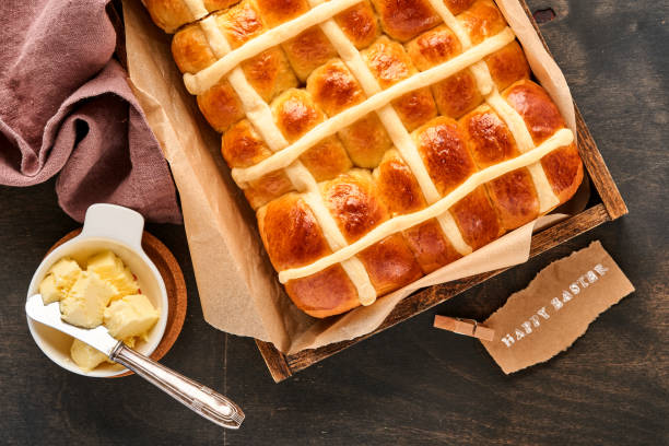 istock Easter Hot Cross Buns. Traditional breakfast and Easter baking holiday decorations rabbiton dark old wooden background. Bright colors, view from above on wooden table. 1314782289