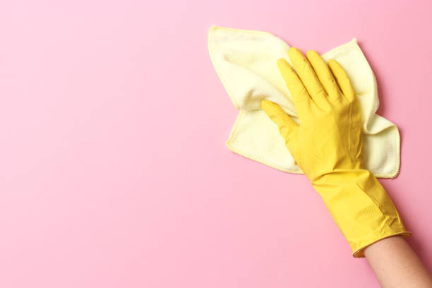 istock female hand in cleaning glove and rag on colored background 1314782835