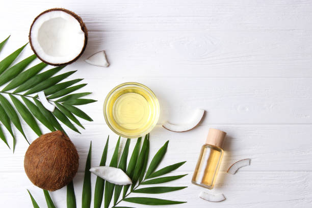 istock coconut oil and coconuts, palm branches close up 1314783619