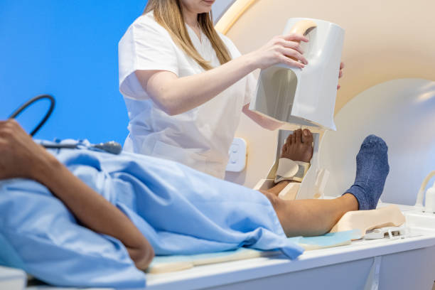 istock Nurse setting additional equipment on patient's foot before MRI scanning. 1314783939