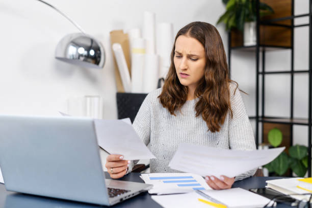 istock Worried female employee doing paperworks 1314784048