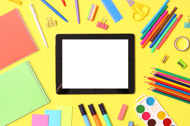 istock Modern digital tablet and school stationery on a colored background top view. 1314784999