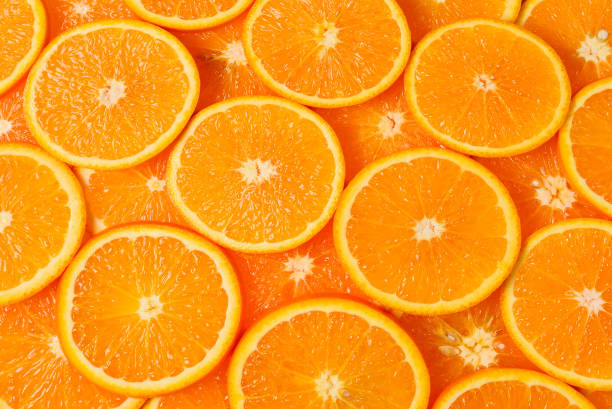 istock Slices of oranges as a background, top view. 1314785350