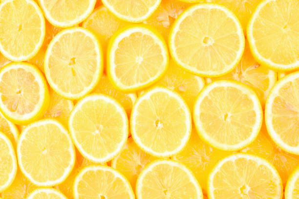 istock A slices of fresh juicy yellow lemons.  Texture background, pattern 1314785387