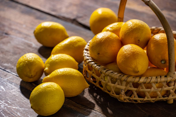 istock Lemons on wooden background. 1314785544