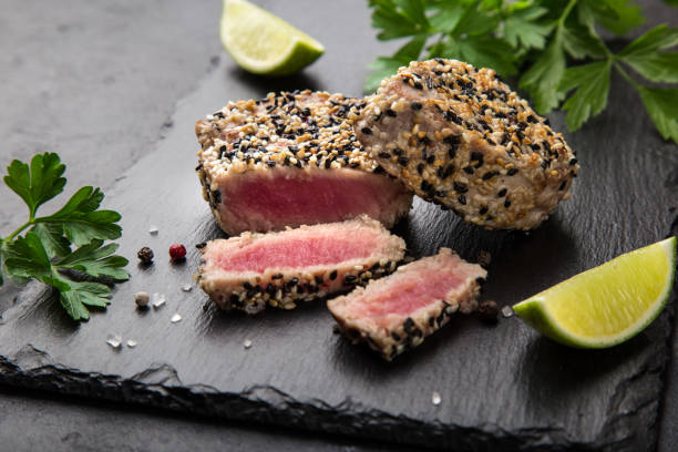 istock grilled sesame tuna steak on black background 1314785669