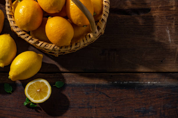 istock Lemons on wooden background. 1314785755