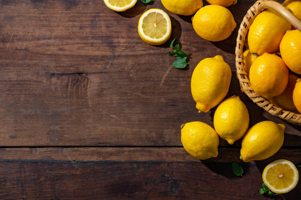 istock Lemons on wooden background. 1314785768