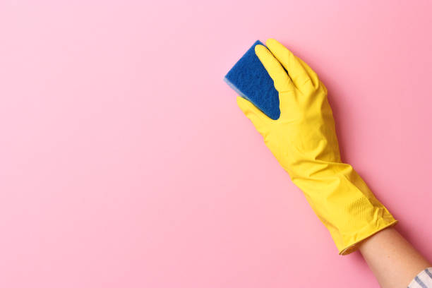 istock female hand in cleaning glove and rag on colored background 1314785849