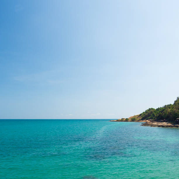 istock front view clear blue sea calm waves. wind blows cool And still, see rocks distance, still see island And sky clear, look relaxed. Suitable relax and travel