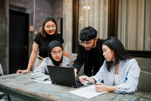 Asian students in the university are presenting to their friends. Student presenting project on tablet, to group of co-students in classroom malay stock pictures, royalty-free photos & images