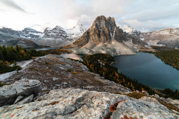 istock looking down at a valley in the mountains with clouds and a lake in the front 1314792471