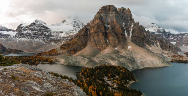 istock looking down at a valley in the mountains with clouds and a lake in the front 1314792624