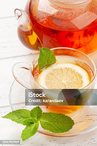 istock Herbal tea with mint and lemon. Tea cup and teapot 1314792959