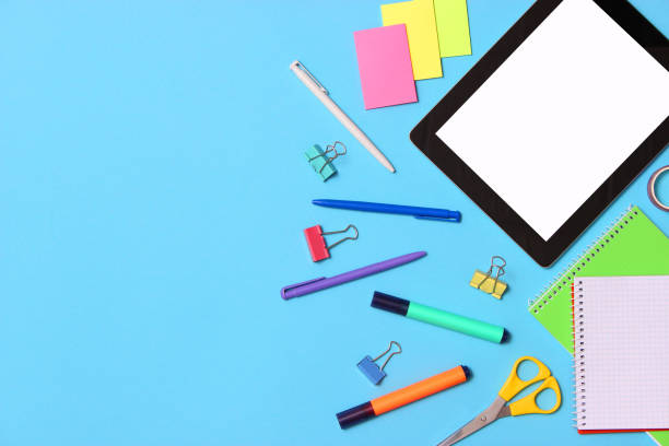 istock Modern digital tablet and school stationery on a colored background top view. 1314794641