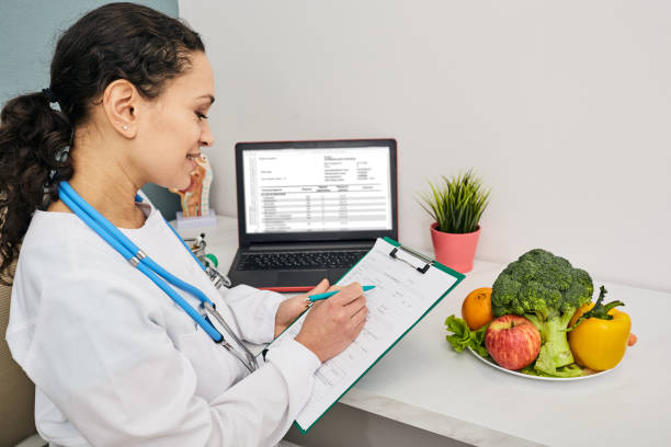 istock Nutritionist creates personalized meal plan for her patient. Vegetables and fruits for a healthy diet 1314797895
