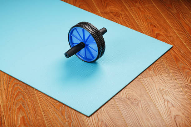 istock Blue roller for abs pumping classes on a blue fitness Mat. 1314798009