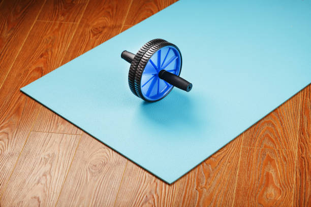 istock Sports roll for training muscles and abs on the blue Mat. 1314798723