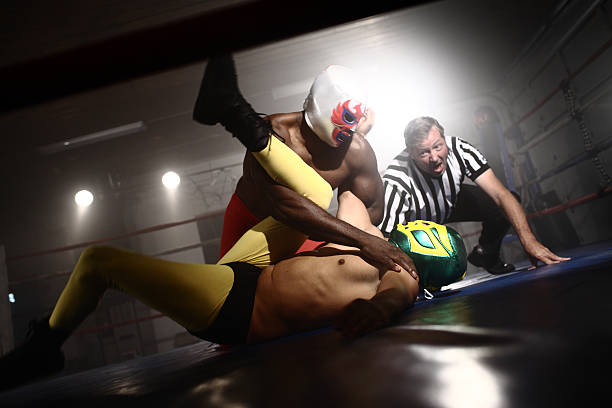 istock Referee watches as two masked wrestlers fight 131479983