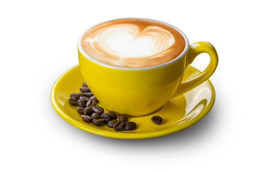 Latte coffee in yellow coffee cup with plate and coffee beans on white background with clipping path