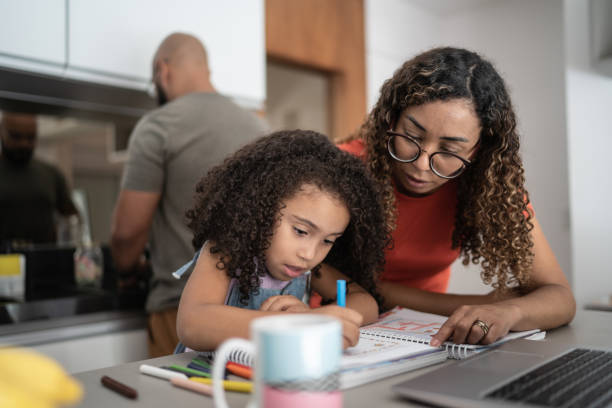 Mother helping daughter with homework