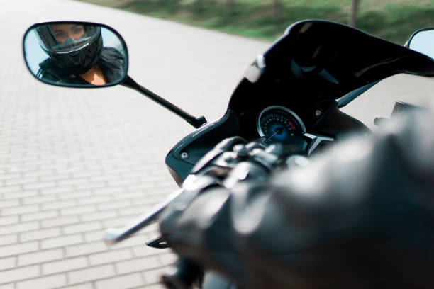 istock Charismatic girl looking herself on motorcycle mirror 1314804237