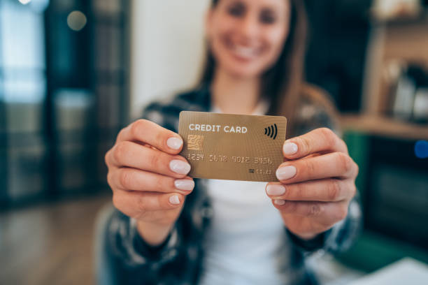 istock Woman holding a credit card. 1314804497