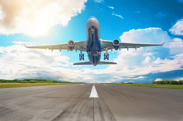istock Rapidly plane taking off runway, airstrip with marking on blue sky with clouds background. Travel aviation concept 1314804809
