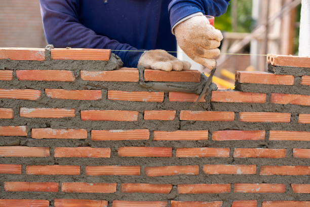 istock hand of professional construction worker laying bricks In wall construction, construction and masonry concept 1314804998